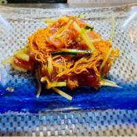 Maguro Poke · Fresh raw fish mixed radish, cucumber, over a 1/2 avocado with honey wasabi sauce & spicy sa...