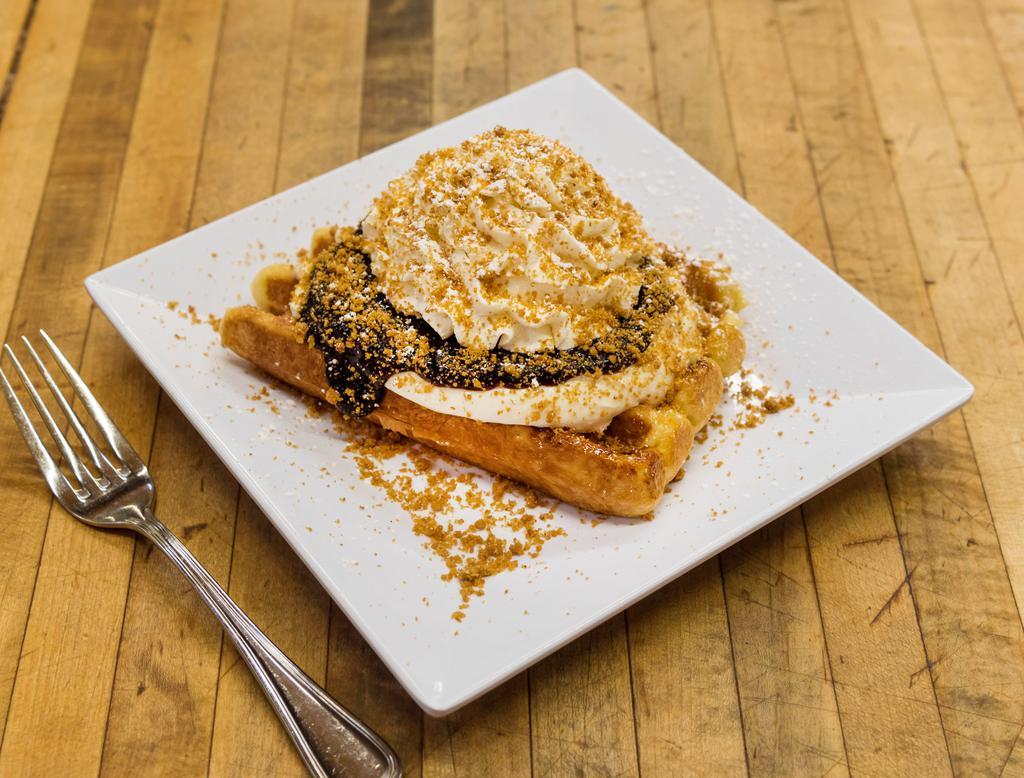 Blueberry Cheesecake Waffle · House recipe blueberry-cinnamon compote, our special cheesecake pudding, Graham cracker crumb topping and whipped cream.