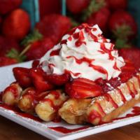 Strawberry Waffle · Fresh strawberries and whipped cream on a waffle with a sprinkling of powdered sugar.