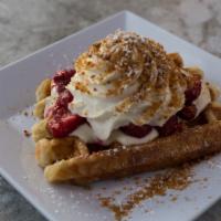 Strawberry Cheesecake Waffle · Fresh strawberries, cheesecake pudding, whipped cream and Graham cracker crumble.