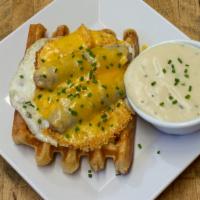 Rise & Shine Waffle · Zenner's chicken apple sausage link, over hard organic fried egg, Tillamook cheddar cheese.