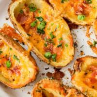 Crispy Potato Skins · Potato skins topped with melted cheese and bacon. Served with sour cream.