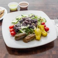 Greek Salad · Mixed greens, tomatoes, cucumbers, crumbled feta, red onions, Kalamata olives, grape leaves ...