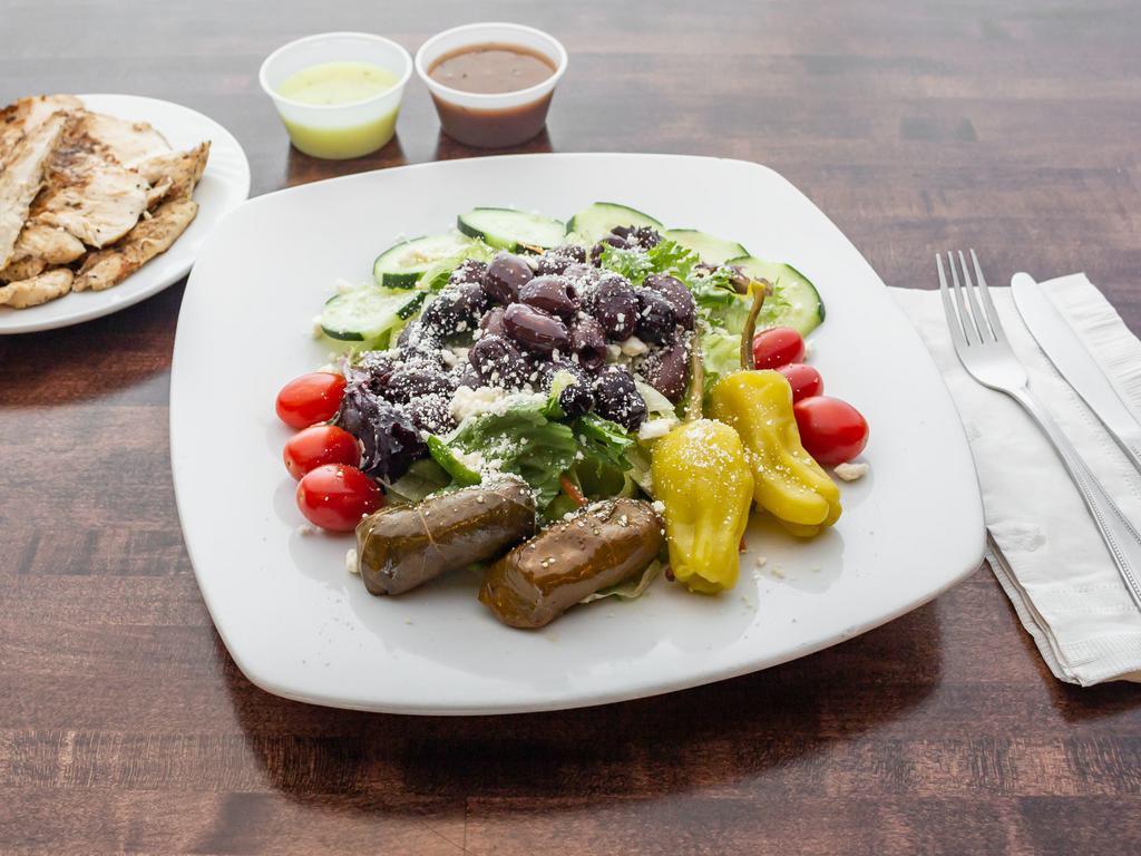 Greek Salad · Mixed greens, tomatoes, cucumbers, crumbled feta, red onions, Kalamata olives, grape leaves and pepperoncini, with our house dressing. Add grilled chicken or shrimp for an additional charge.