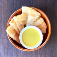 Crispy Roti with Curry Sauce · Crispy roti pancakes served with yellow curry or red curry sauce.