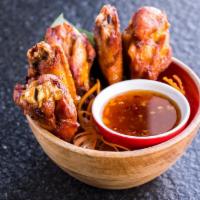 Fried Chicken Wings · Six (6) pieces. Deep-fried chicken wings. Served with house-made sweet chili sauce.