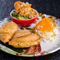 Vegetarian Spiral Curry Puffs · Three (3) pieces. Crispy pastry stuffed with vegetables and potatoes. Served with cucumber s...