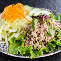 Chicken Larb Salad (Gluten-Free) · Minced chicken salad mixed with red onions, mint, cilantro, lime juice, and ground roasted r...