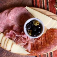 Picada Portena · Assorted cured meats, manchego, and Asiago cheese with olives.