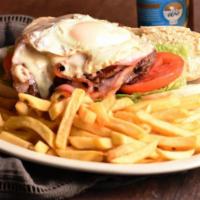 Chivito Uruguayo · Steak on French bread with tomato, lettuce, ham, bacon, onions, melted cheese, and a fried e...