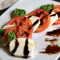 Ensalada Caprese · Caprese salad, tomato slices over mozzarella fresh and balsamic vinegar.