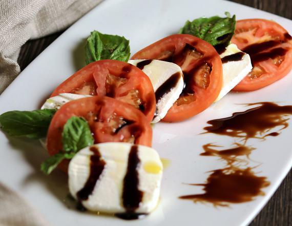 Ensalada Caprese · Caprese salad, tomato slices over mozzarella fresh and balsamic vinegar.