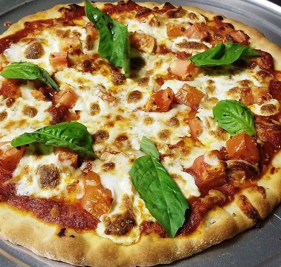 Pizza Margherita · Marinara sauce, fresh tomato chopped, mozzarella cheese chunks, and fresh basil leaves.