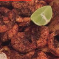 Botana de Camaron · Cajun seasoned shrimp. Served with potato and corn. Made with tomato, onion, cilantro and ja...