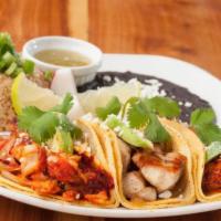 Taco Trio · 3 small tacos: 1 fish, 1 shrimp chorizo and 1 chicken. Served with fried rice, refried black...