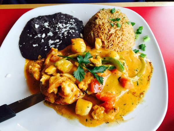 Pollo Bandera · Whole chicken breast, topped with sauteed shrimp, scallops, crab meat, onions, tomato, bell pepper and creamy sauce. Served with fried rice and refried black beans.
