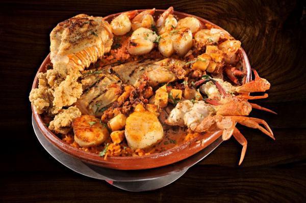 Parrillada en Barro for 2 · Lobster tail, jumbo shrimp, fish, crab meat, octopus, oyster and hot sauce. Served in a bed of rice. Black beans and tortillas.