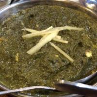 Saag Paneer · Cooked spinach with homemade Indian cheese cubes, spices and herbs.
