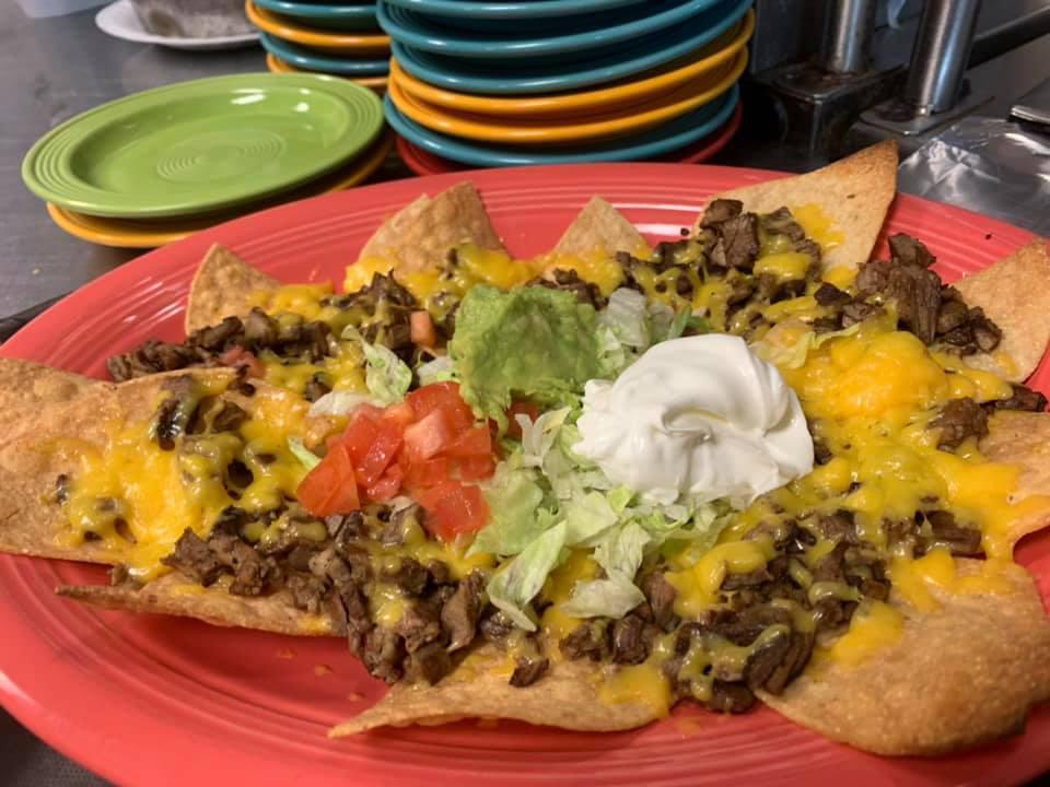 Nachos la Cabana · Corn tortilla chips topped with beans, beef or chicken fajitas, American cheese, guacamole, sour cream, and jalapenos.