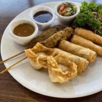 13. Silver Spoon Sampler Platter · A combination of two pieces of chicken satays, prawns rolls, spring rolls, and crab delight.
