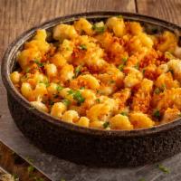 Mac & Cheese · Ooey, gooey, cheesy goodness – cavatappi with aged cheddar and parmesan in a deep dish pan.