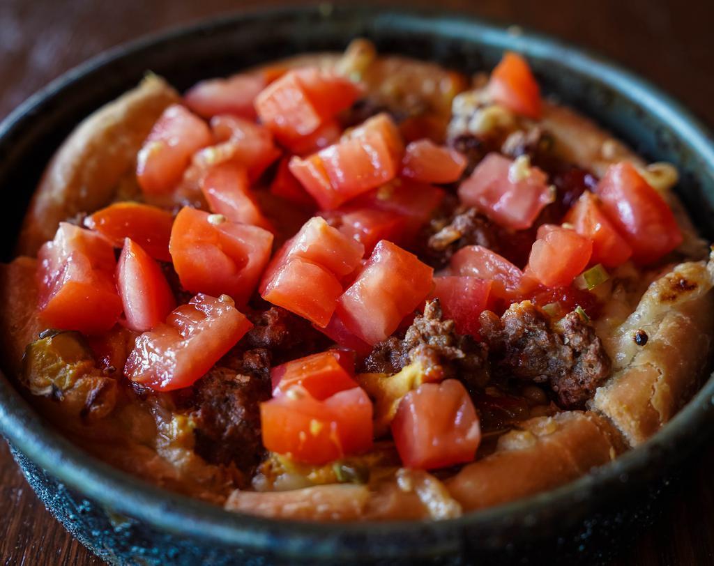 Vegan Cheeseburger Deep Dish (individual) · Our deep dish crust filled with vegan cheese and topped with crumbled BEYOND BEEF® patty, caramelized onions, diced pickles and a drizzle of ketchup and mustard.