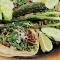 Tacos · 3 tacos per order. Double white corn tortilla with your meat of choice. Topped with fresh on...