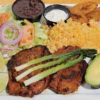 Grilled Marinated Pork Platter · Served with rice, beans, green salad, scallions, avocado, sweet plantains, sour cream, and t...