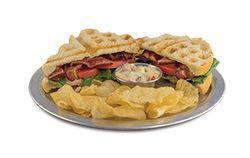 BLT · Bacon, lettuce, and tomato on sourdough bread, served with chips, pickle spear, and a side o...