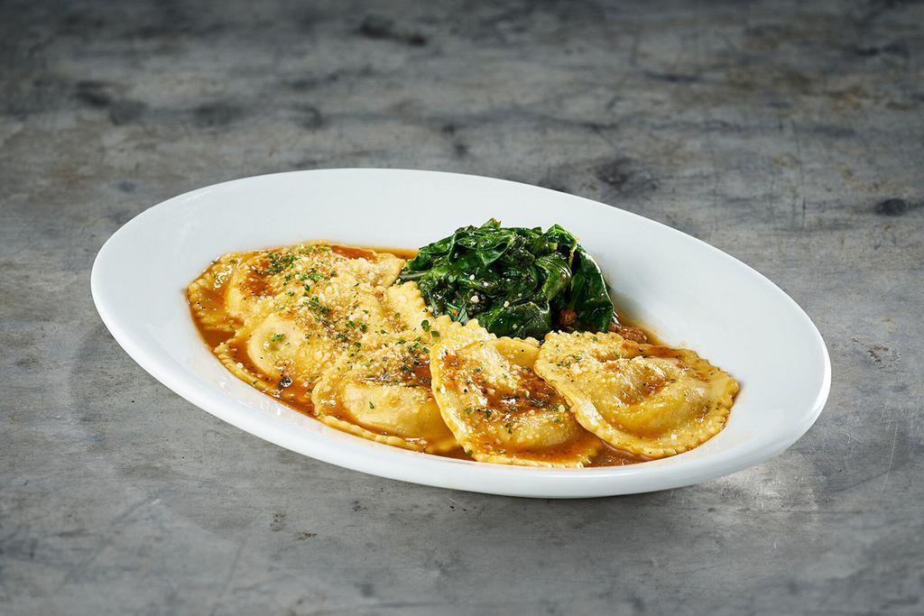 Veal Osso Buco Ravioli · Saffron-infused pasta with sautéed baby spinach and white wine demi-glace.