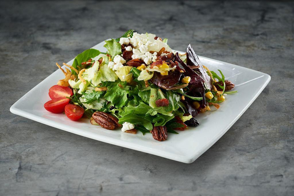 Harvest Salad · Mixed greens, roasted corn, dried cherries, bacon, tomatoes, white balsamic vinaigrette, goat cheese, cajun pecans, and crispy onions.
