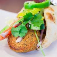 Falafel Gyro · 3 chick peas puffs, baked golden brown atop toasted pita , lettuce, hummus, spinach, tomatoe...