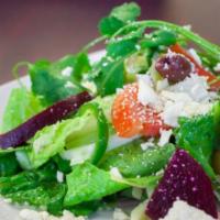 Greek Salad  · Crisp romaine lettuce, red onions, tomatoes, olives, cucumber, pepperoncini, seasonal veggie...
