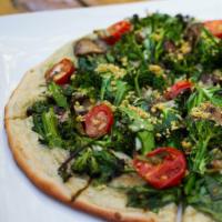 WHITE TRUFFLE PIZZA · broccolini, spinach & mushrooms tossed with white truffle oil, baked over cashew cheese, top...
