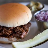 Chopped Beef Sandwich · Smoked Beef Brisket Sauteed with our Tangy Sauce. Served with Chopped Red Onion & Pickles
