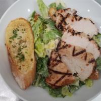 Chicken Caesar Salad  · Grilled chicken romaine hearts tossed with housemaid dressing shaved Parmesan and focaccia c...