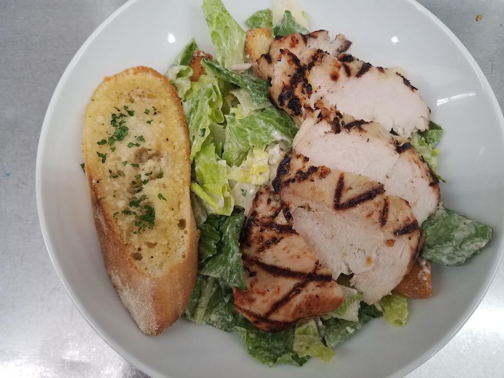 Chicken Caesar Salad  · Grilled chicken romaine hearts tossed with housemaid dressing shaved Parmesan and focaccia croutons