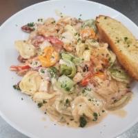 Cajun  Pasta · Andouille Sausage, Shrimp and chicken with peppers and onions in a rich cajun cream sauce ov...