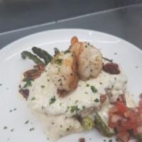Chicken Baton Rouge · Sautéed chicken topped with parmesan cream and garnished with shrimp and pecans.  Served wit...