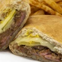 Qbano Sandwich · Roasted pork, ham, Swiss cheese, mustard, and pickles pressed on Cuban bread. Served with fr...