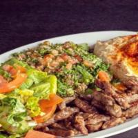 Beef Shawarma Plate · Beef Shawarma with garden salad, tabouli, hummus and bread.