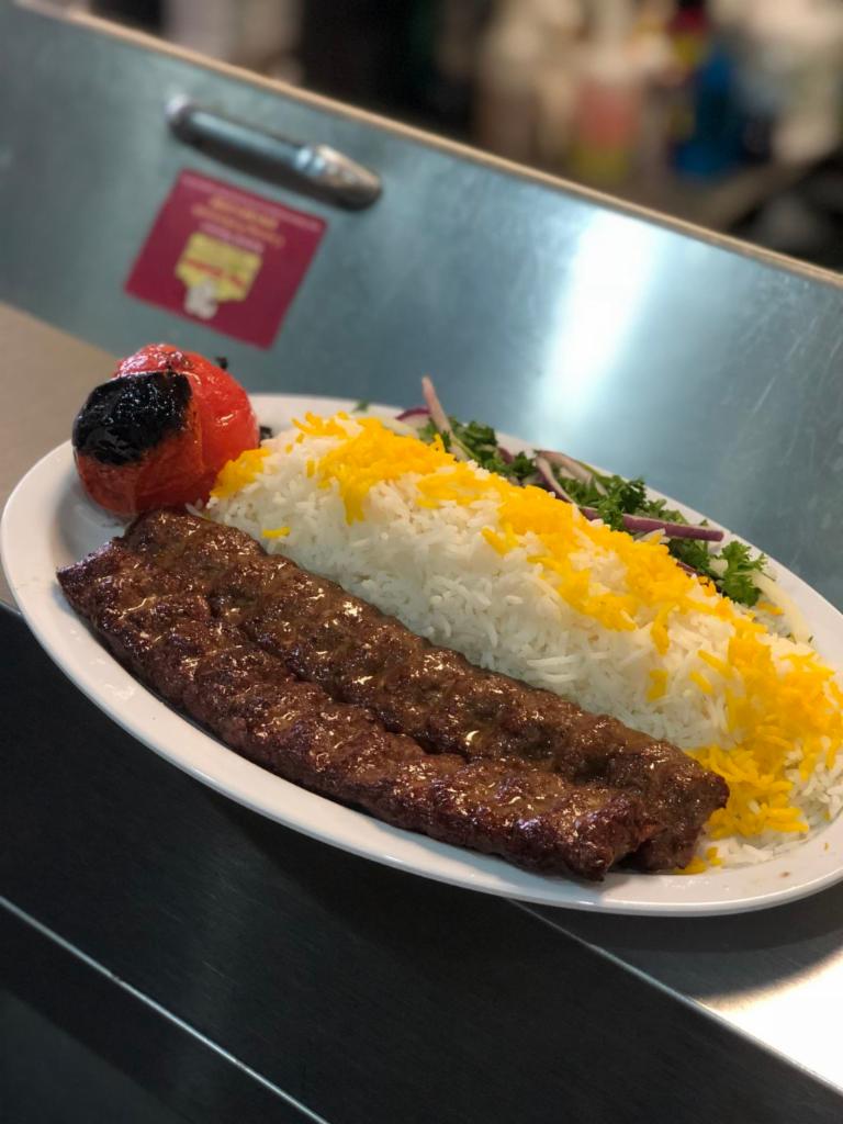 Beef Luleh Kebab · Ground beef mixed with special spices and onion, 2 skewers. Served with hummus, rice, pita bread, grilled tomato, onion & parsley.