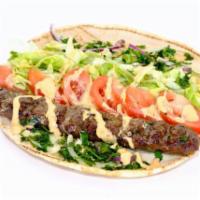 Beef Luleh Kebab Wrap · Lettuce, tomato, fries, parsley and onion in a wrap topped with our special sauce.