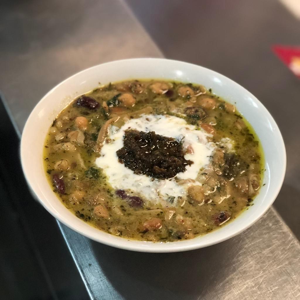 Ashe-Reshte Soup · Mixture of spinach, cilantro, beans, lentils and noodles topped with fried onion, fried mint and kashk.