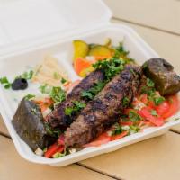 Kofta Over Salad Platter · Grilled ground beef made with Egyptian spices drizzled with tahini sauce on top of salad. Pi...