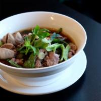 Beef Noodle Soup · Rice noodle, beef sliced, beef strew and meat ball in brown soup with green onion and cilant...