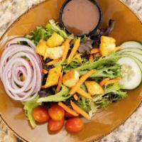 Tossed Green Salad · Field greens, tomatoes, cucumbers, red onion, shredded carrots, garlic croutons.