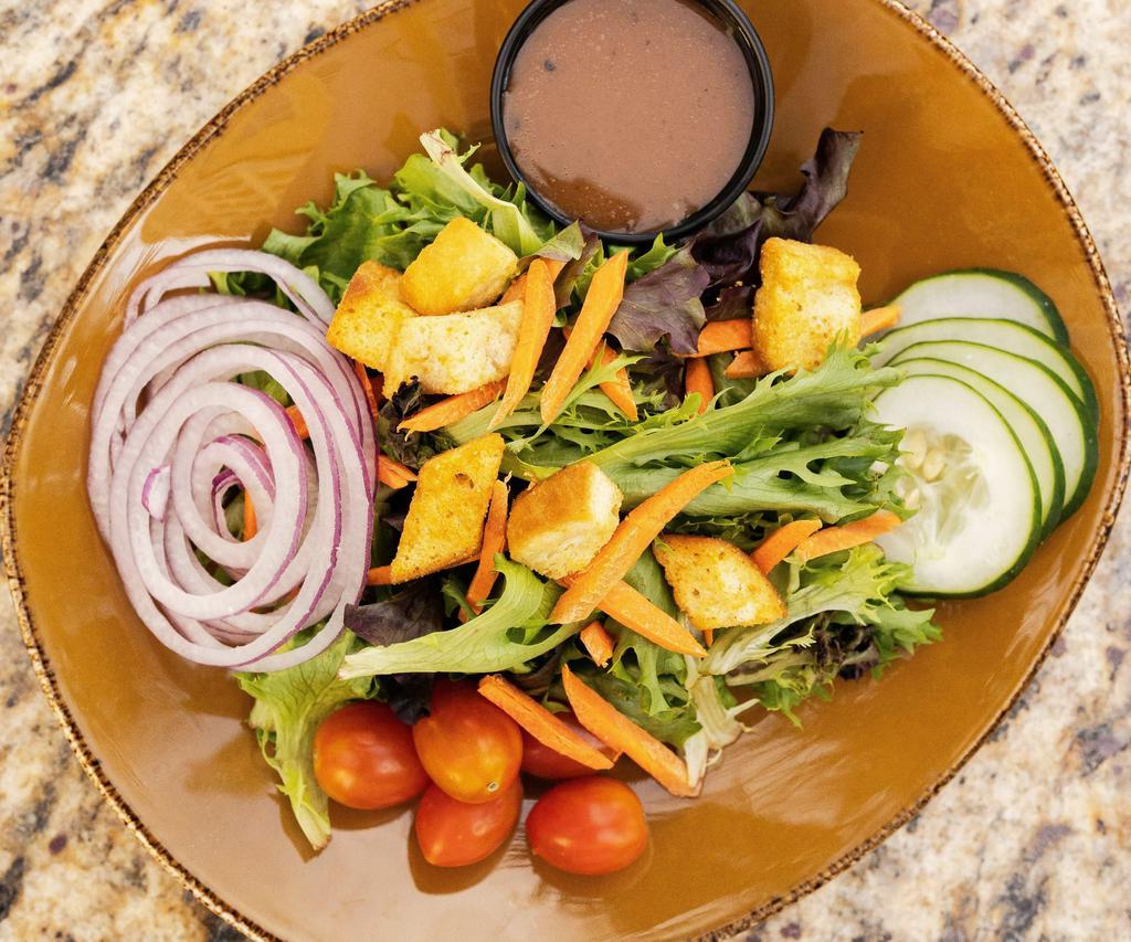 Tossed Green Salad · Field greens, tomatoes, cucumbers, red onion, shredded carrots, garlic croutons.