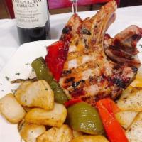 Pork Chop · Grilled 20 oz. bone-in, double thick cut pork chops topped with homemade vinegar peppers and...