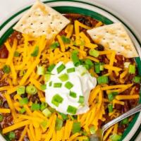 Chili Soup · Homemade chili topped with green onions, shredded chedder, sour cream ots.
